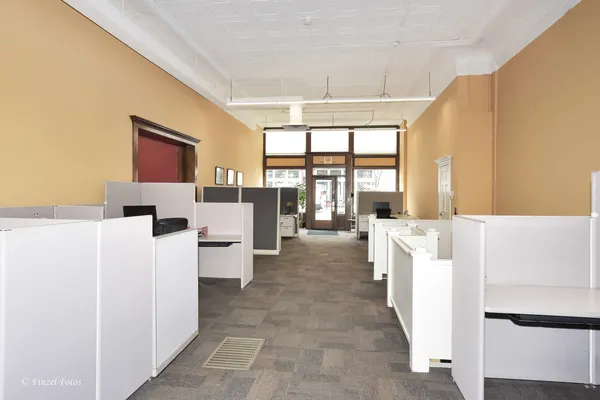 a living room with furniture and large windows