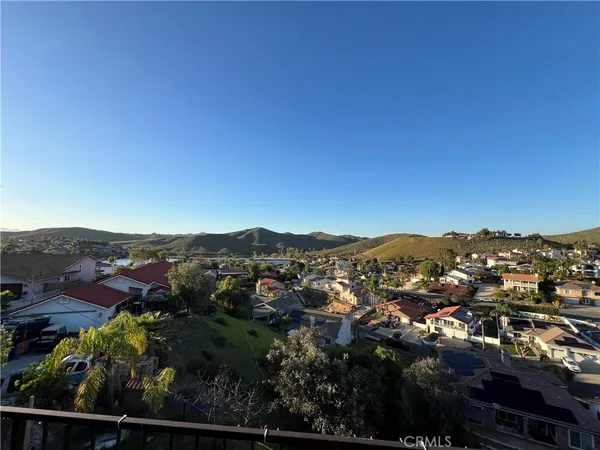 an aerial view of residential houses with outdoor space and trees