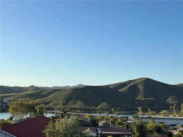 a front view of a house with a mountain