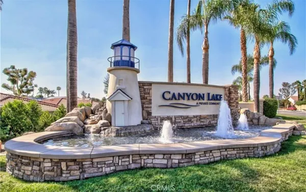 a view of a house with a yard and potted plants