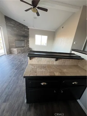 a view of room with kitchen island and wooden floor