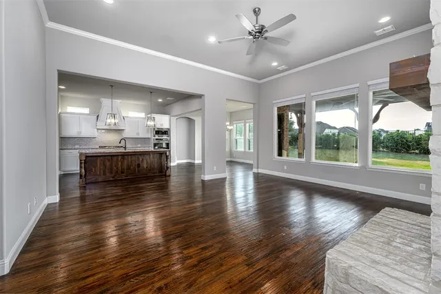 a view of a kitchen with wooden floor and a kitchen