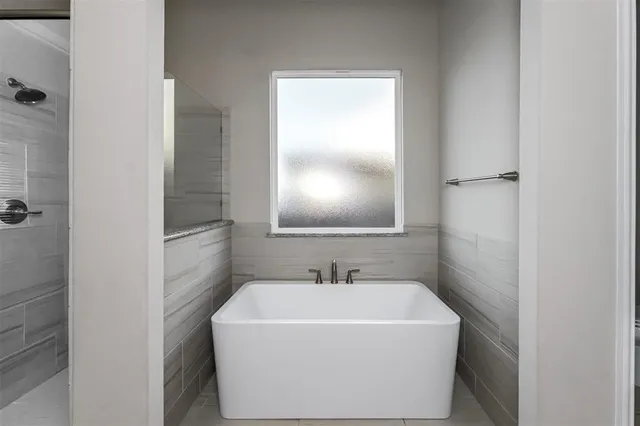 a white bath tub sitting next to a white sink
