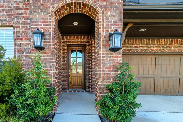a front view of a house with plants