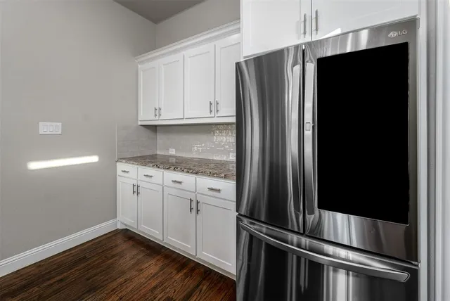 a kitchen with metallic refrigerator freezer and a dishwasher