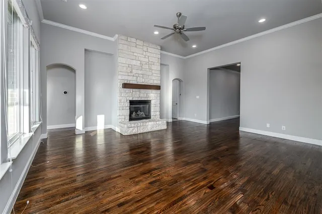 a view of empty room with wooden floor and fireplace