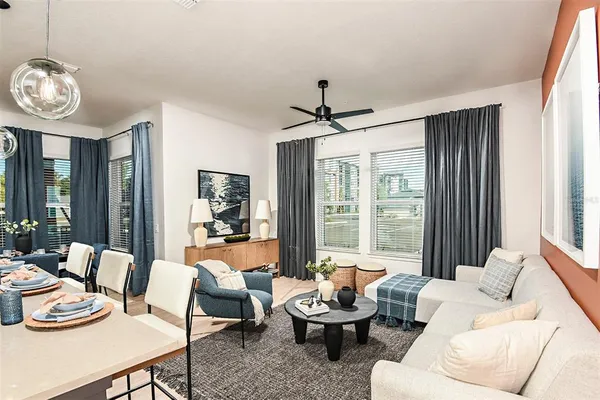 a bedroom with a bed next to a window with a flat screen tv