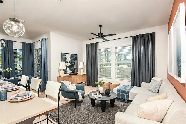 a bedroom with a bed next to a window with a flat screen tv