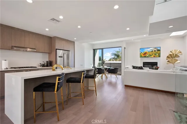 a living room with furniture a dining table and kitchen view