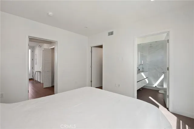 a bedroom with a bed and hallway