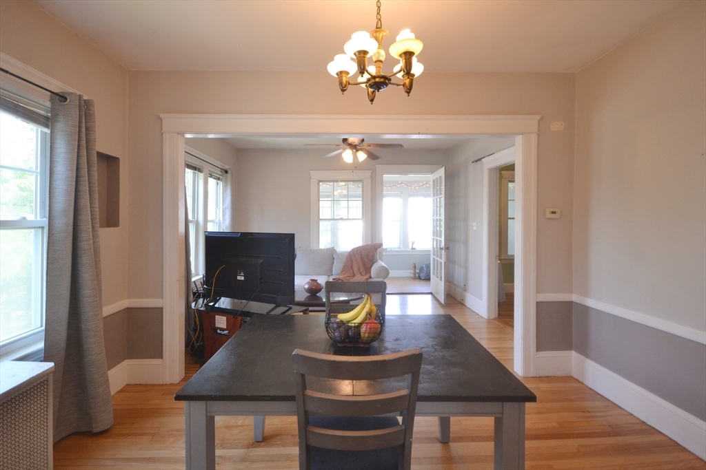 118 King Philip Road Worcester, MA 01606 - Photo 12 of 28 a view of a dining room with furniture a chandelier and wooden floor
