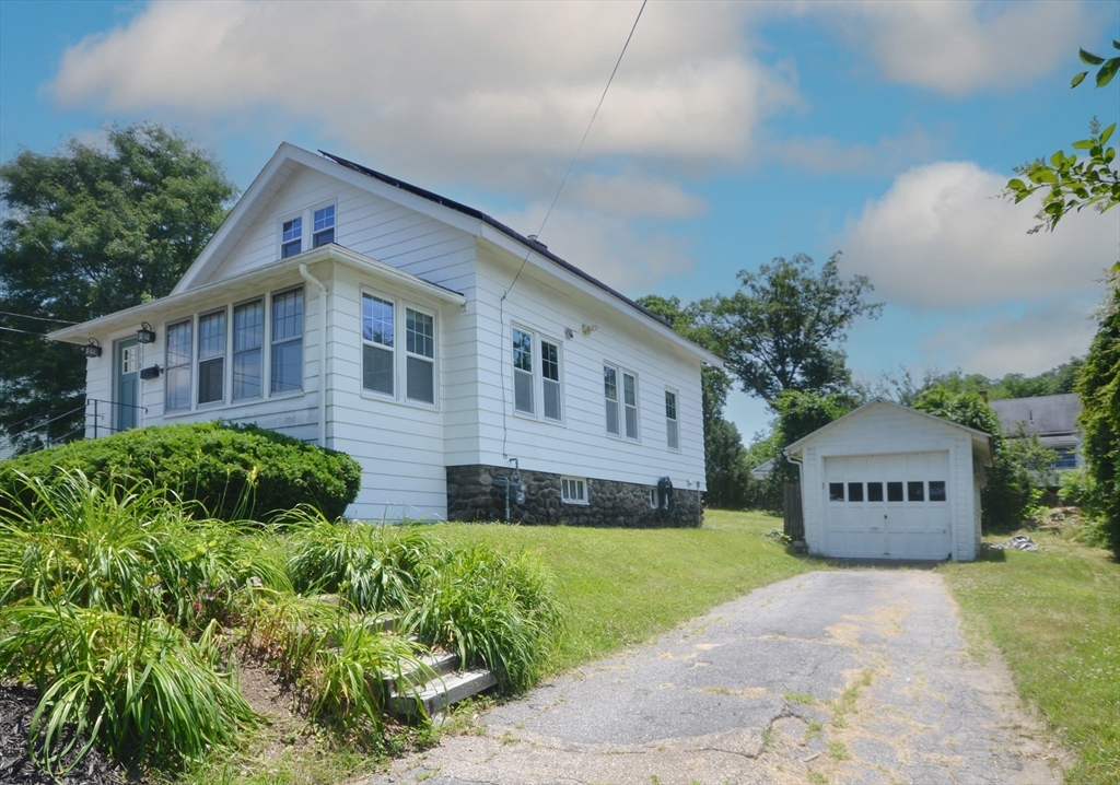 118 King Philip Road Worcester, MA 01606 - Photo 2 of 28 a front view of a house with a yard and garage