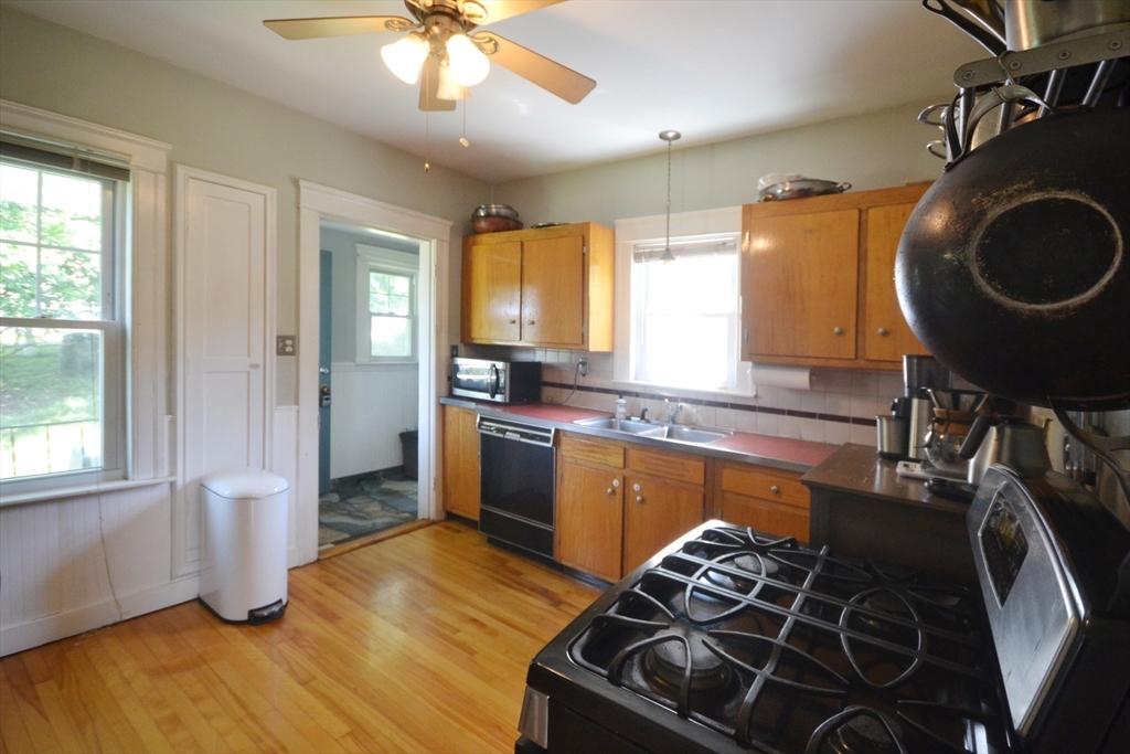 118 King Philip Road Worcester, MA 01606 - Photo 5 of 28 a kitchen with granite countertop a stove and a wooden floors