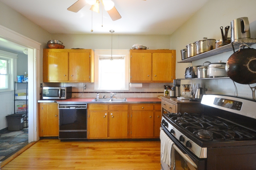 118 King Philip Road Worcester, MA 01606 - Photo 6 of 28 a kitchen with stainless steel appliances granite countertop a stove a sink dishwasher and a dining table with cabinets