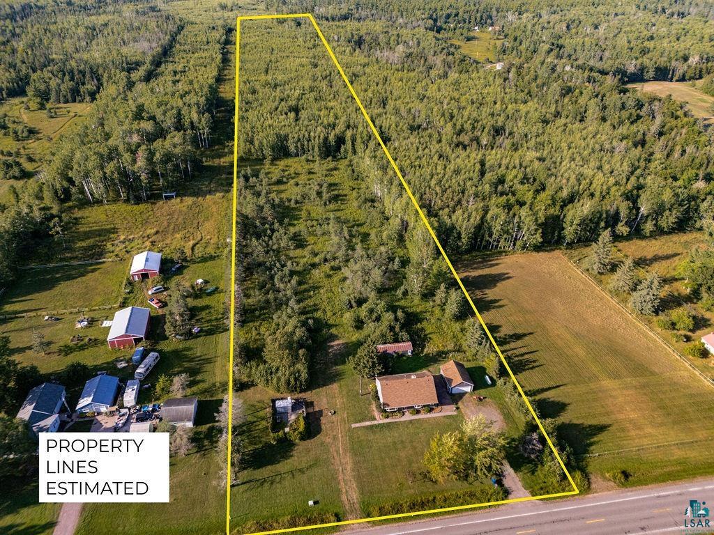 3949 East County Rd B Superior, WI 54880 - Photo 3 of 50 Expansive land parcel featuring a main residence, multiple outbuildings, and mature tree cover
