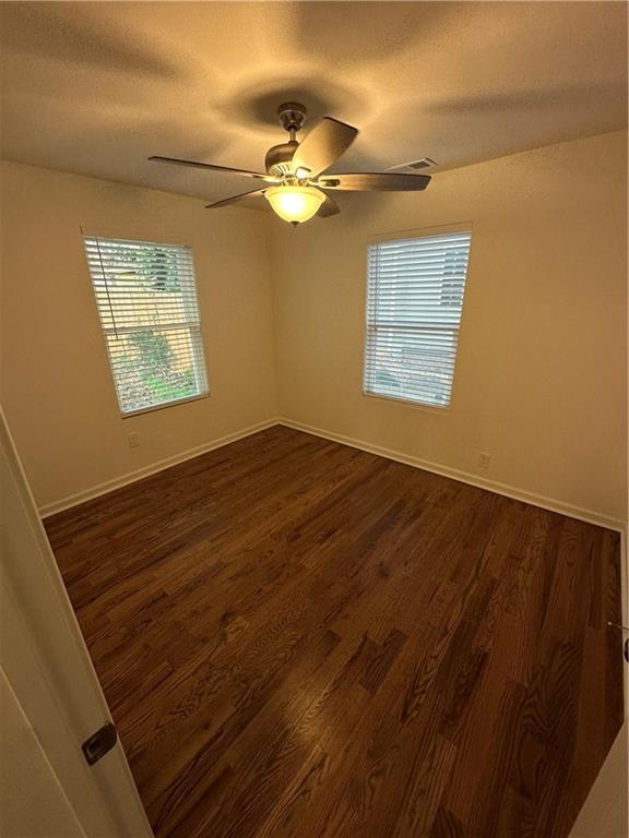 1577 Campbellton Road Southwest Atlanta, GA 30311 - Photo 12 of 23 a view of an empty room with wooden floor and a window