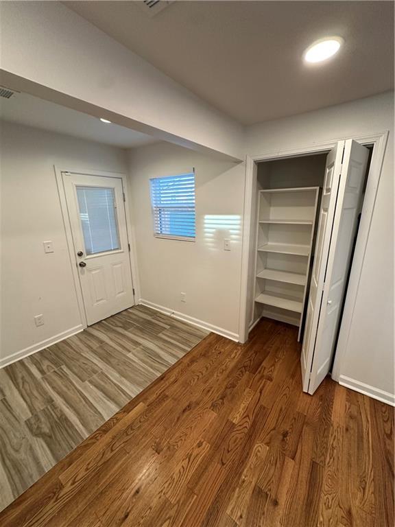 1577 Campbellton Road Southwest Atlanta, GA 30311 - Photo 15 of 23 a view of a room with wooden floor and closet