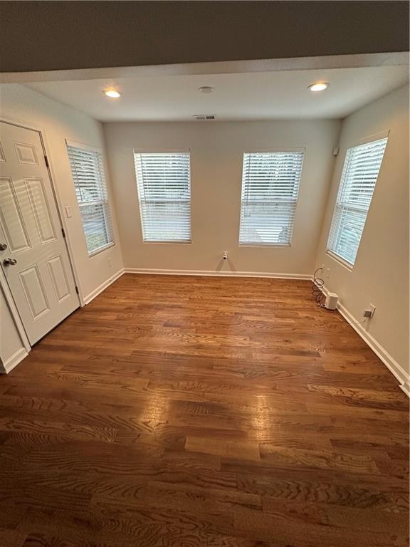 1577 Campbellton Road Southwest Atlanta, GA 30311 - Photo 16 of 23 a view of an empty room with wooden floor and a window