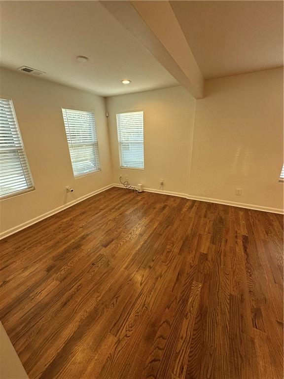1577 Campbellton Road Southwest Atlanta, GA 30311 - Photo 10 of 23 an empty room with wooden floor and windows