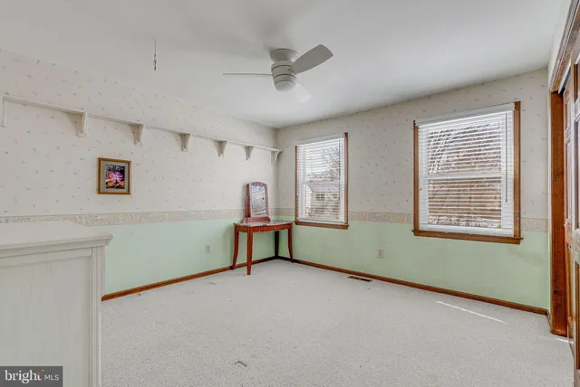 a view of room with window and ceiling fan