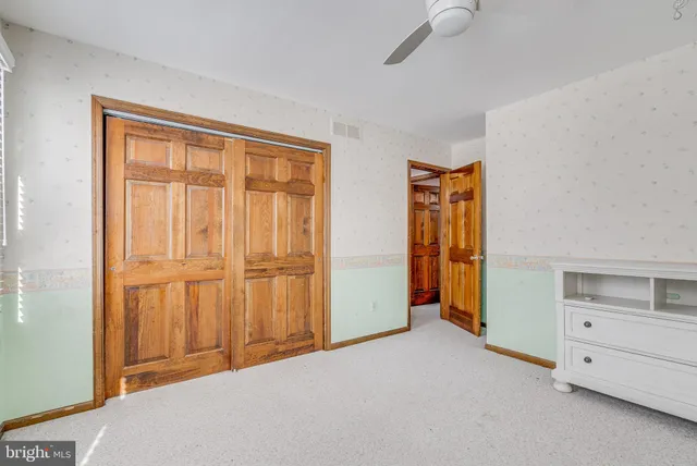 a view of an empty room with closet and cabinet