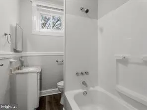 a bathroom with a bathtub and a sink