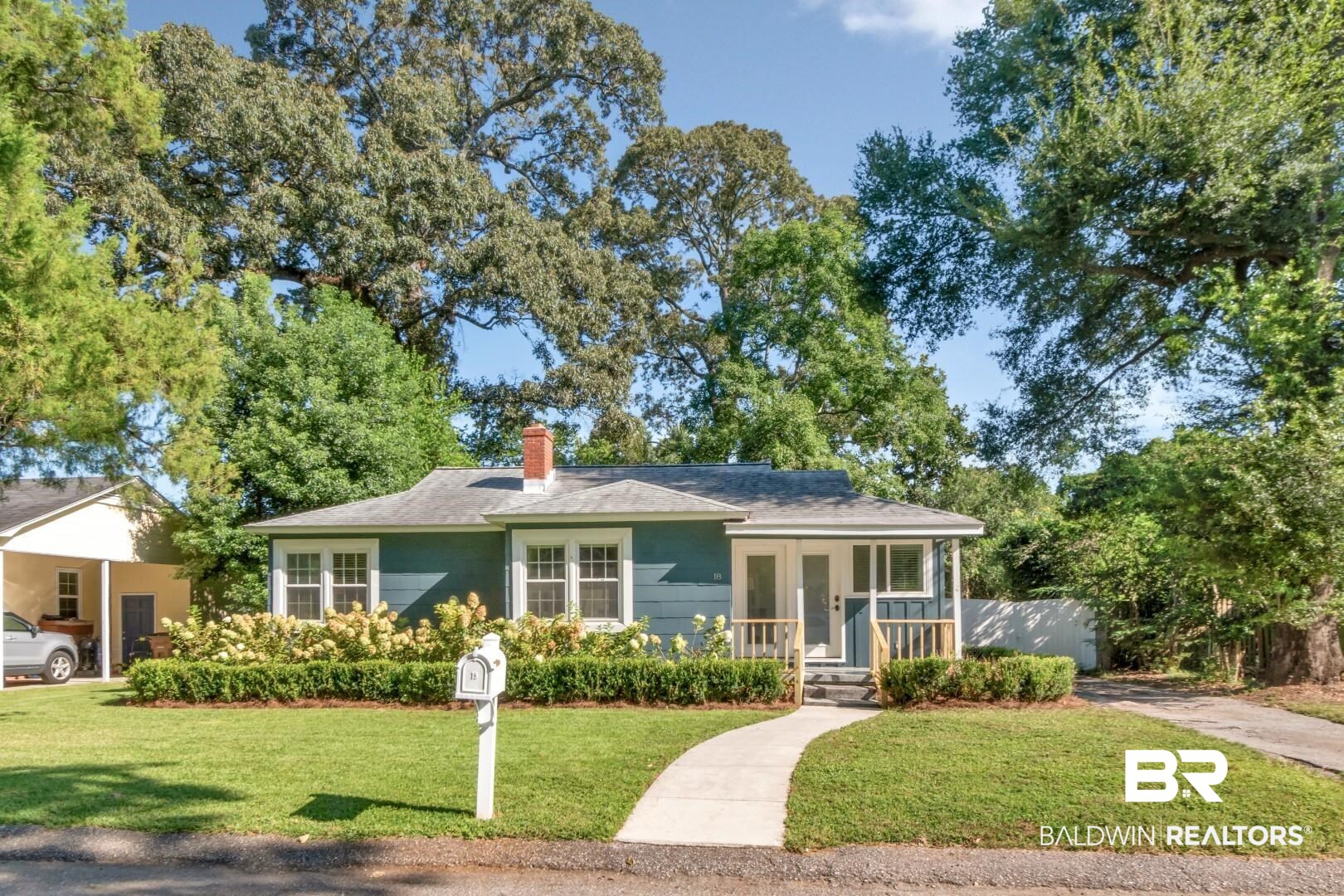 18 Princess Anne Road Mobile, AL 36608 - Photo 40 of 41 View of front of home with a front yard, covered porch, a chimney, and roof with shingles