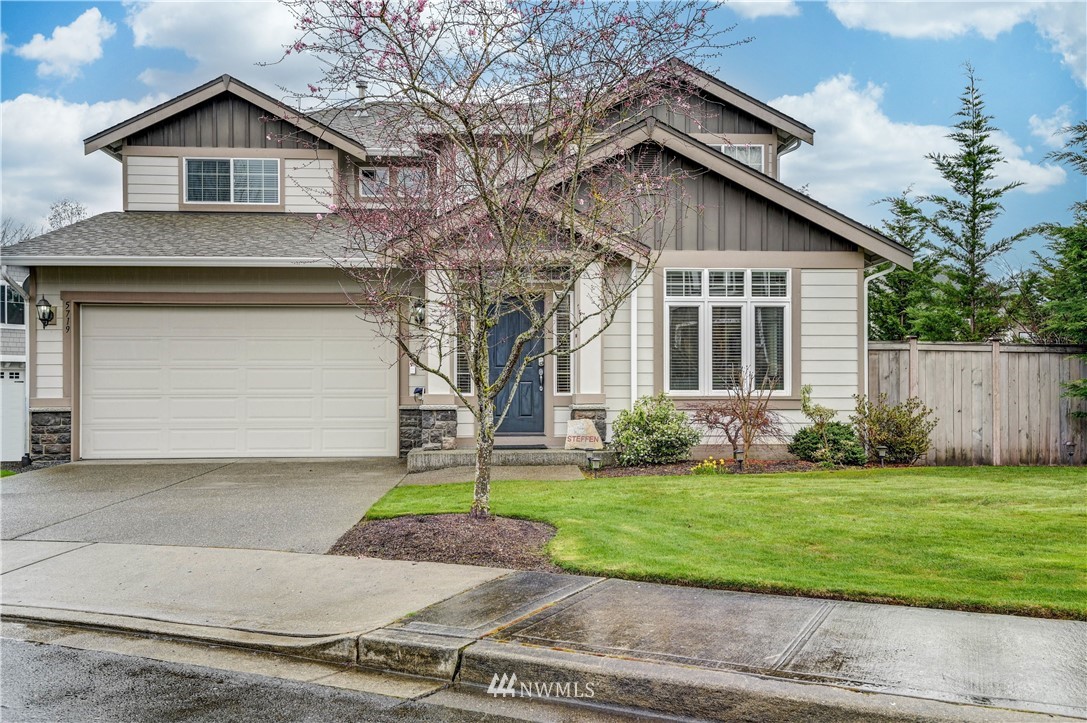 a front view of a house with a yard and garage