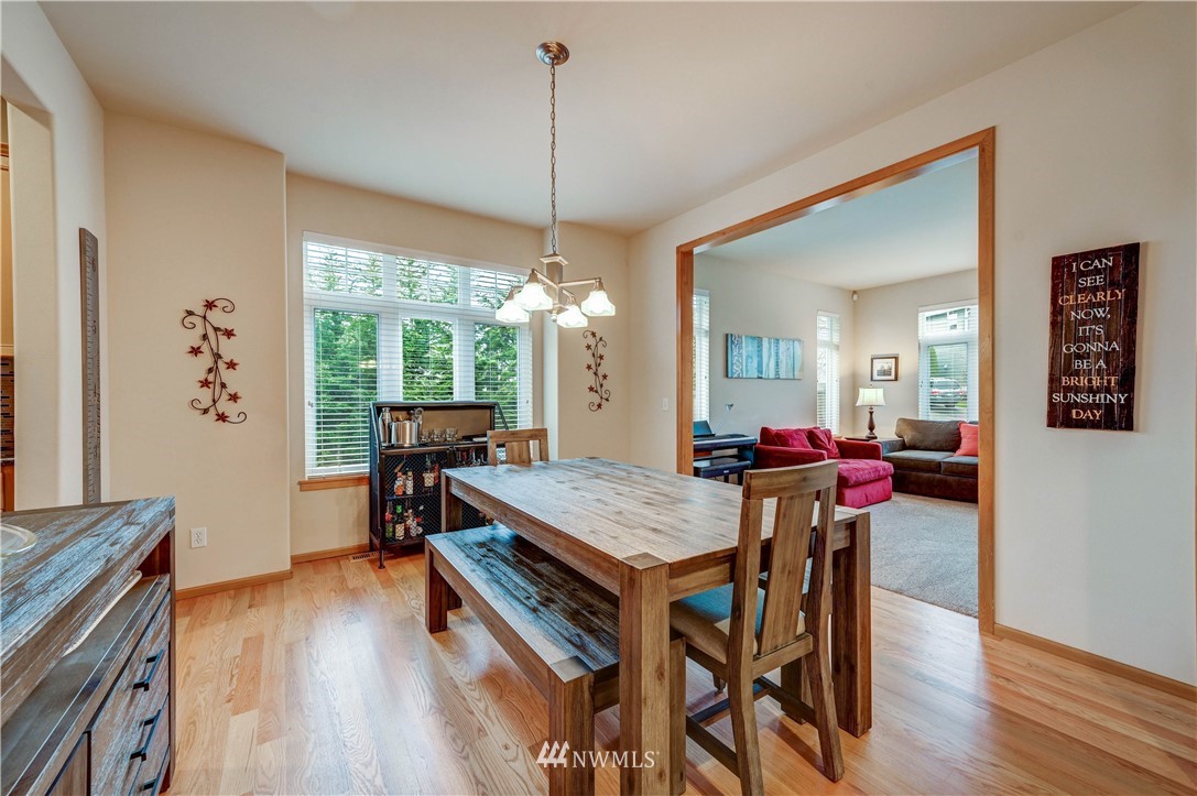 5719 Northeast 3rd Street Renton, WA 98059 - Photo 11 of 40 a view of a dining room with furniture window and wooden floor