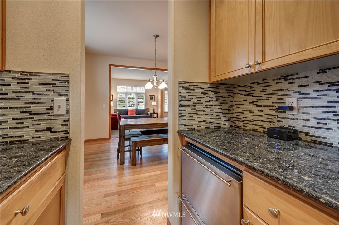 5719 Northeast 3rd Street Renton, WA 98059 - Photo 12 of 40 a kitchen with granite countertop a sink and a stove