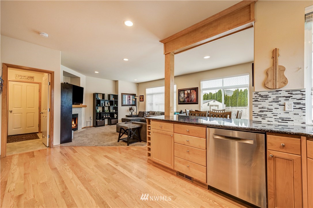 5719 Northeast 3rd Street Renton, WA 98059 - Photo 16 of 40 a large kitchen with kitchen island sink stainless steel appliances and furniture