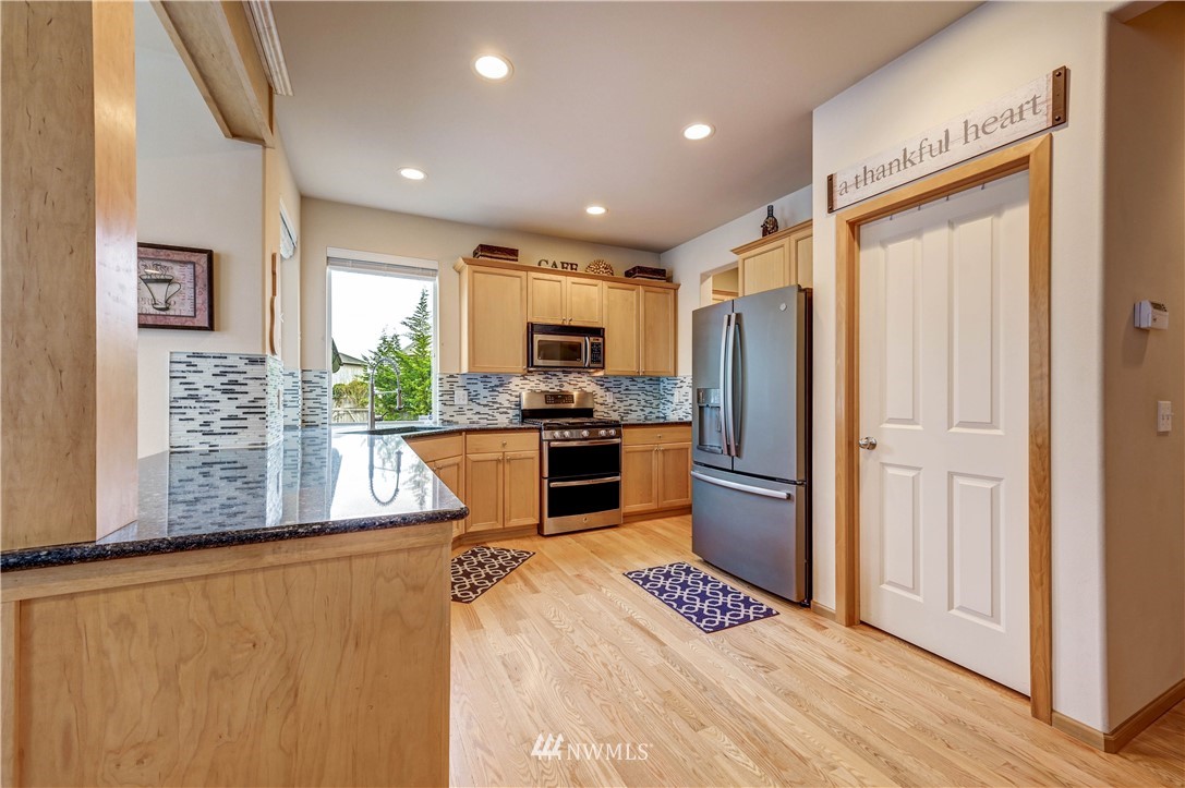5719 Northeast 3rd Street Renton, WA 98059 - Photo 19 of 40 a kitchen with a refrigerator a sink and cabinets