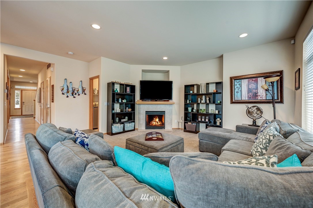 5719 Northeast 3rd Street Renton, WA 98059 - Photo 23 of 40 a living room with furniture a fireplace and a flat screen tv