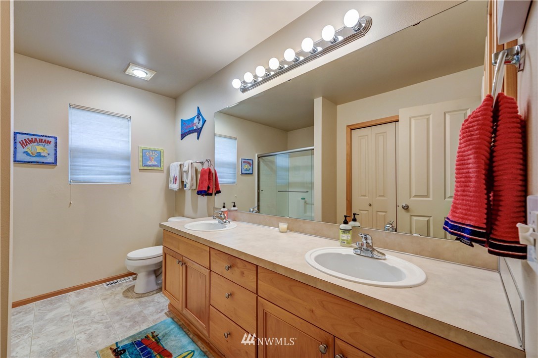 5719 Northeast 3rd Street Renton, WA 98059 - Photo 27 of 40 a bathroom with a sink and a mirror