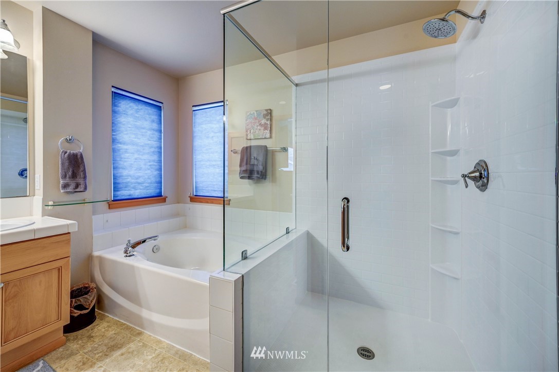 5719 Northeast 3rd Street Renton, WA 98059 - Photo 30 of 40 a bathroom with a tub a sink and a shower