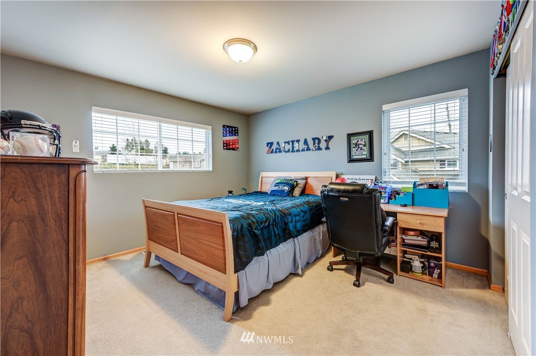5719 Northeast 3rd Street Renton, WA 98059 - Photo 32 of 40 a bedroom with a bed and a window