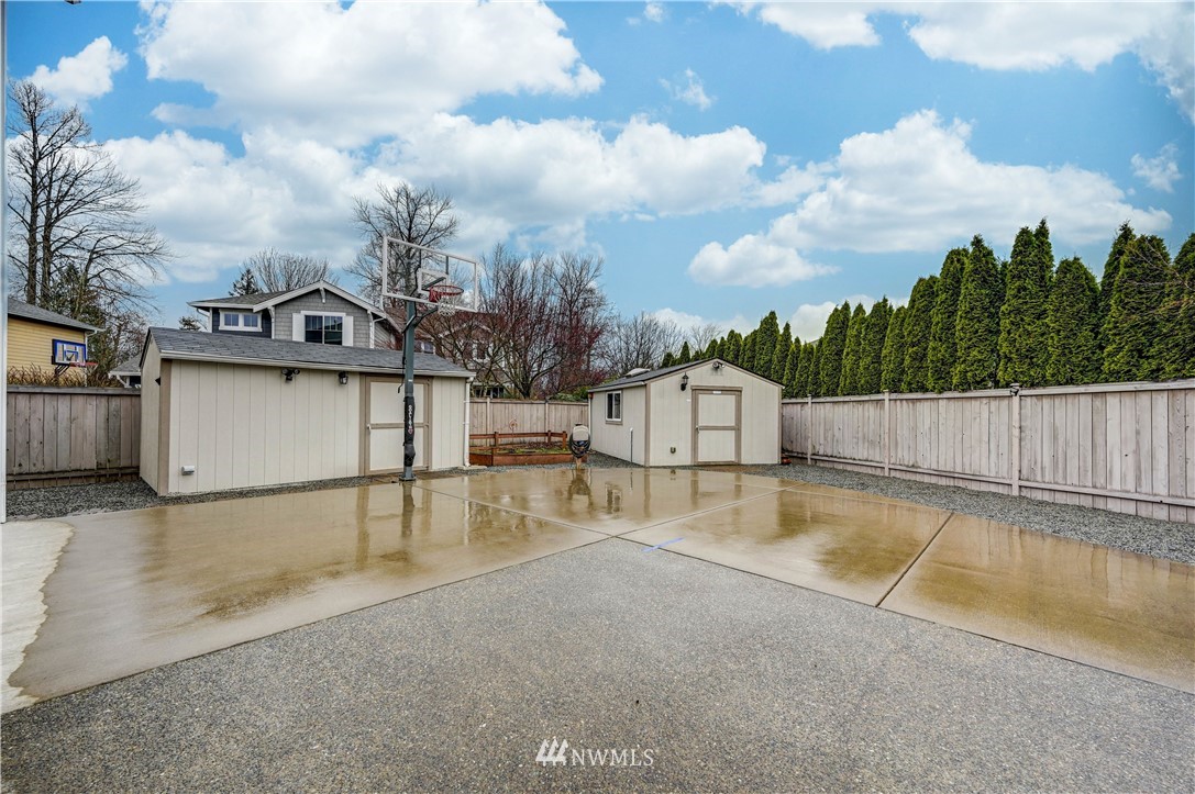 5719 Northeast 3rd Street Renton, WA 98059 - Photo 33 of 40 a view of a white house with a swimming pool and sitting area
