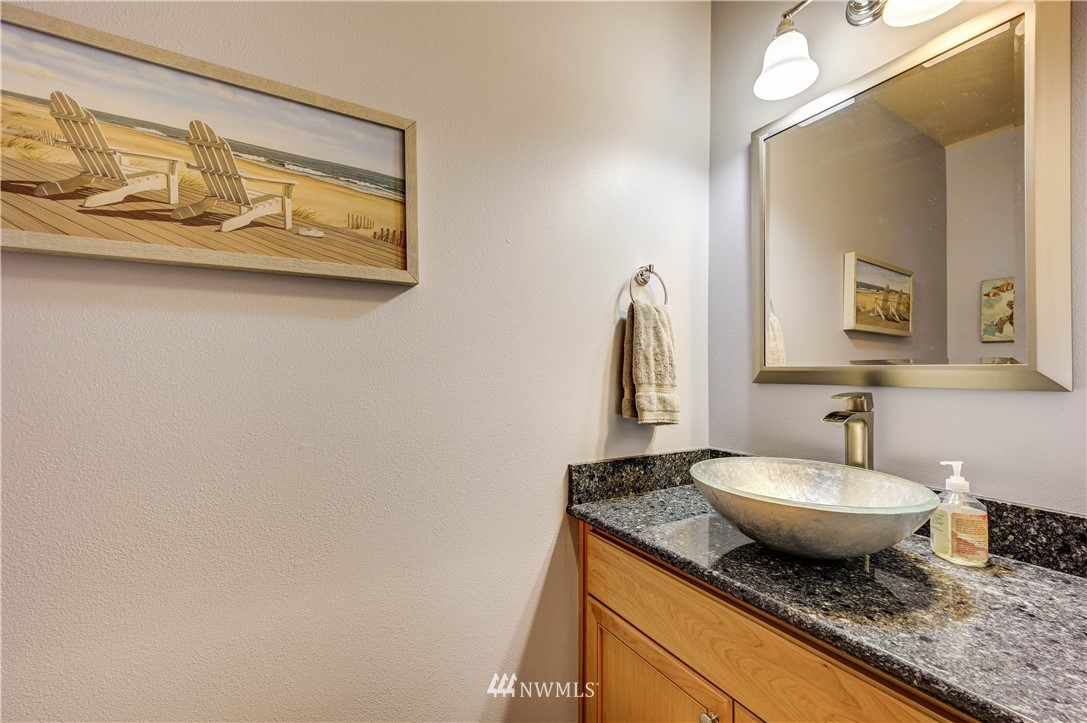 5719 Northeast 3rd Street Renton, WA 98059 - Photo 9 of 40 a bathroom with a granite countertop sink and a mirror