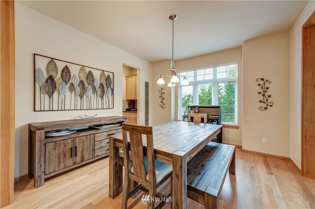 5719 Northeast 3rd Street Renton, WA 98059 - Photo 10 of 40 a dining room with furniture a rug a potted plant and wooden floor