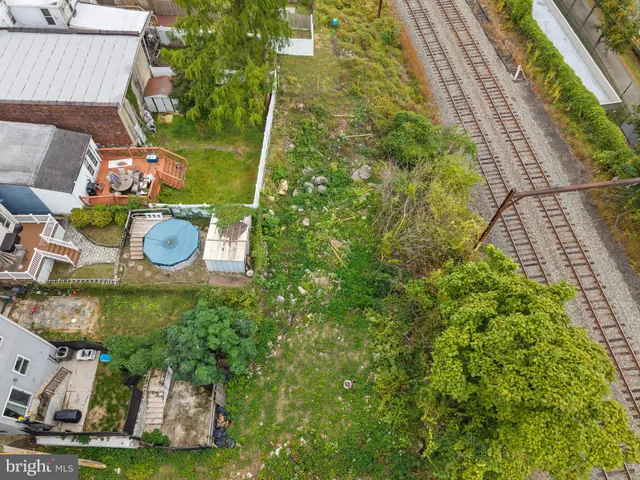 a backyard of a house with lots of green space and garage