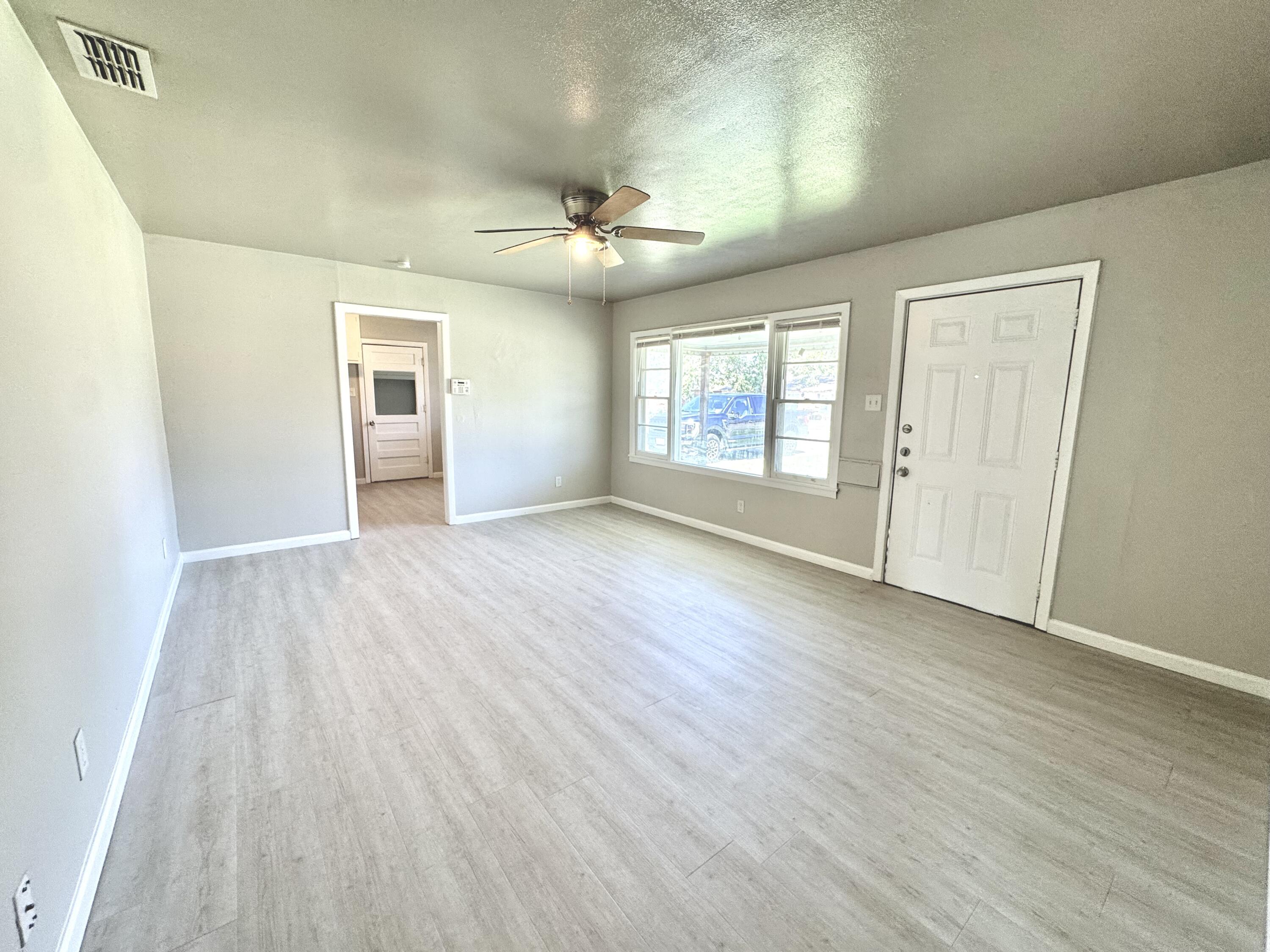 3805 35th Street Lubbock, TX 79413 - Photo 4 of 11 wooden floor in an empty room with a window