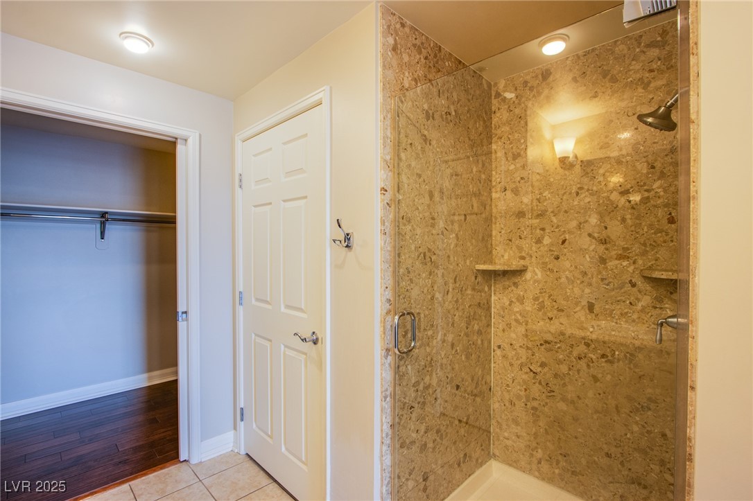 150 South Las Vegas Boulevard, Unit 1212 Las Vegas, NV 89101 - Photo 20 of 45 Full bathroom with a stall shower, tile patterned flooring, and baseboards