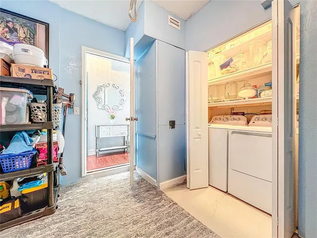 a view of a chairs and table in backyard of the house