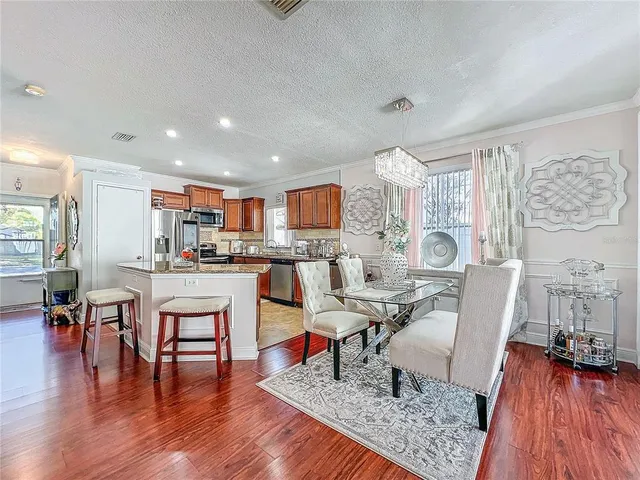 a bedroom with a large bed a flat tv screen and dresser