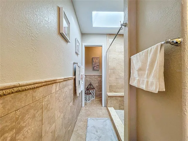a view of a house with sitting area and wooden fence