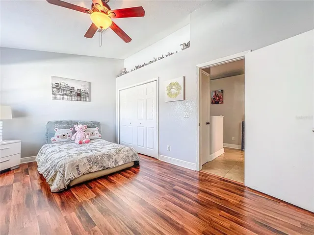 an aerial view of residential houses with outdoor space and lake view in back