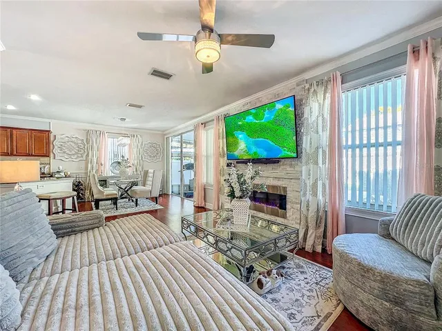 a living room with furniture a fireplace and a flat screen tv