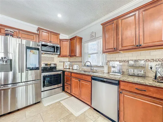 a view of a living room with a flat screen tv and staircase