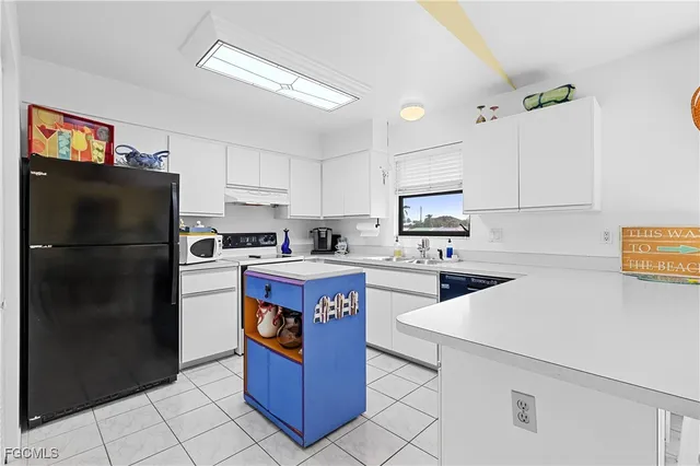 a kitchen with a stove a sink and a refrigerator