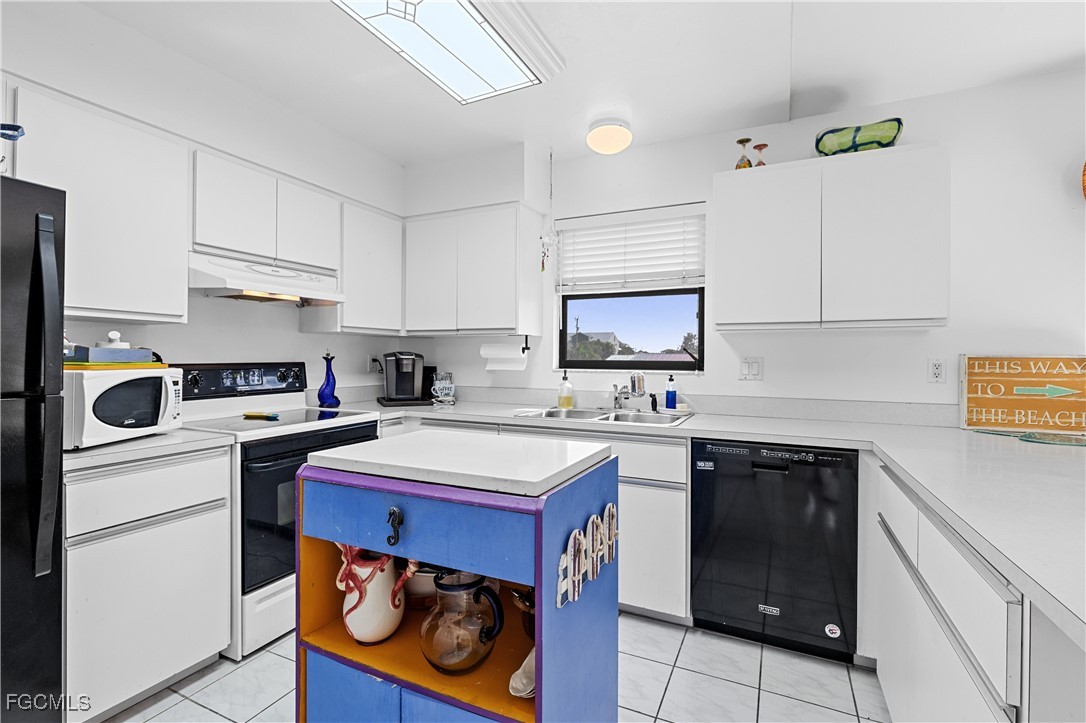 2831 Janet Street Matlacha, FL 33993 - Photo 13 of 43 a kitchen with a stove a sink and a refrigerator